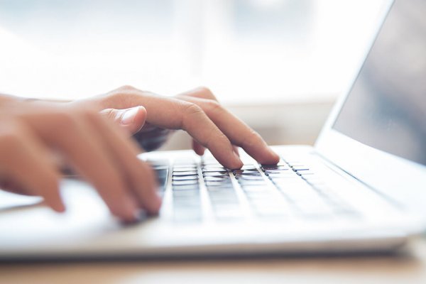person typing on a laptop