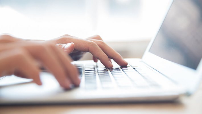 person typing on a laptop